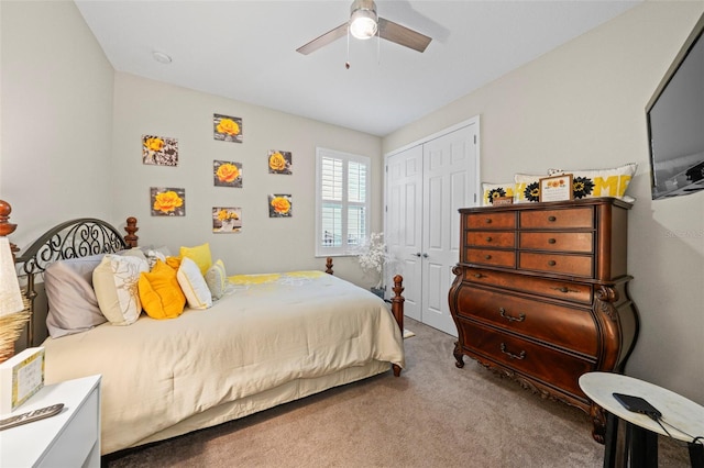 carpeted bedroom featuring ceiling fan and a closet