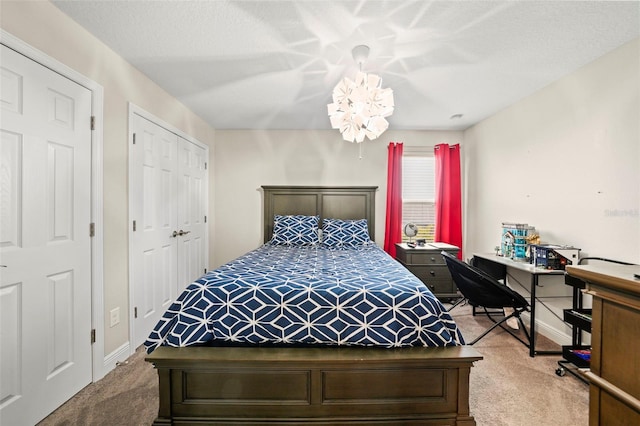 bedroom with carpet and a chandelier