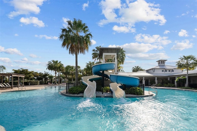 view of swimming pool with a pergola and a water slide