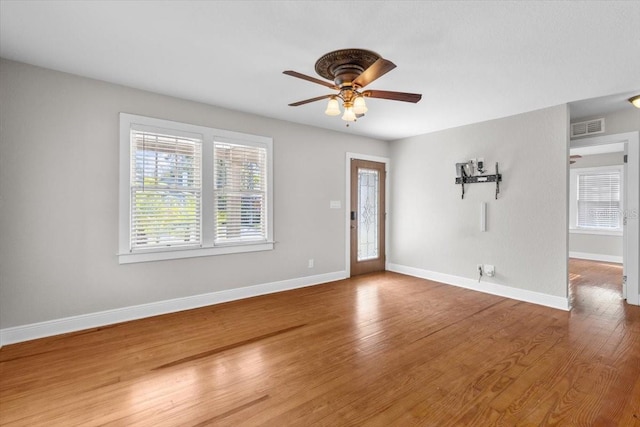 empty room with hardwood / wood-style flooring and ceiling fan