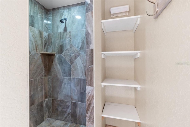 bathroom with a tile shower