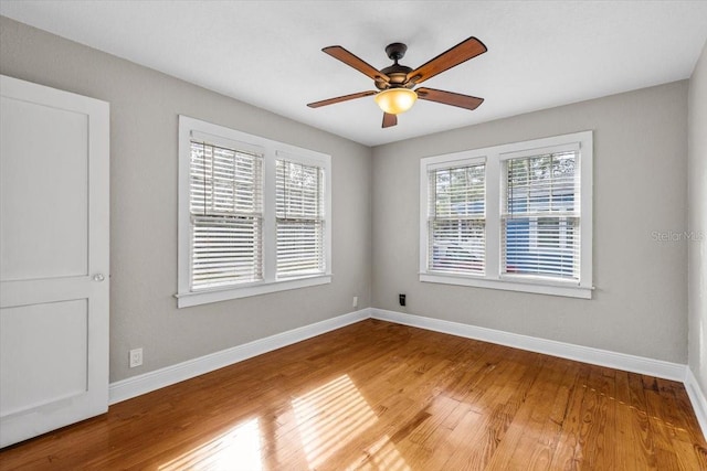 unfurnished room with hardwood / wood-style flooring and ceiling fan