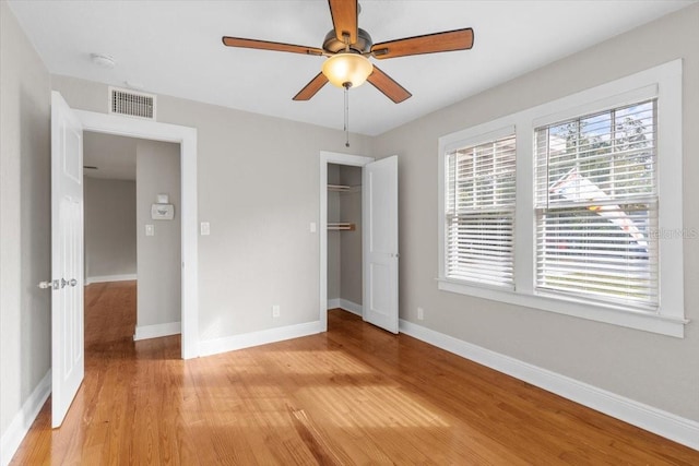 unfurnished bedroom featuring ceiling fan, a closet, and light hardwood / wood-style floors