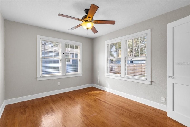 unfurnished room with ceiling fan and hardwood / wood-style flooring