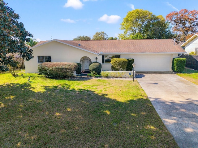 single story home with a front yard and a garage