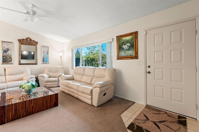 living room with a textured ceiling, ceiling fan, tile patterned flooring, and lofted ceiling