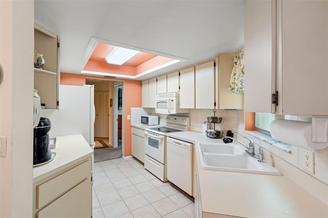 kitchen with tasteful backsplash, sink, white appliances, and light tile patterned flooring