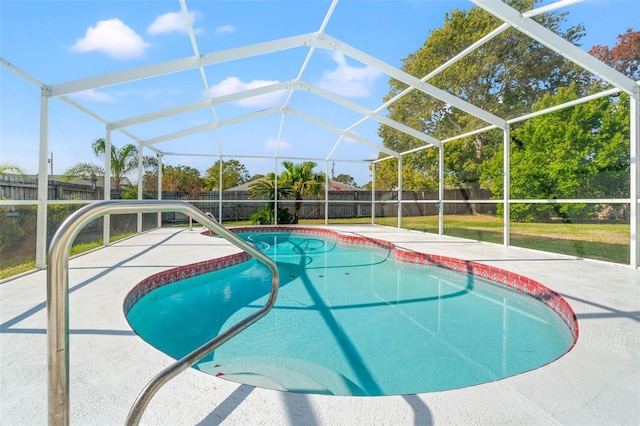 view of swimming pool with glass enclosure and a patio area