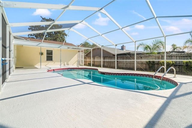 view of swimming pool with a lanai and a patio area