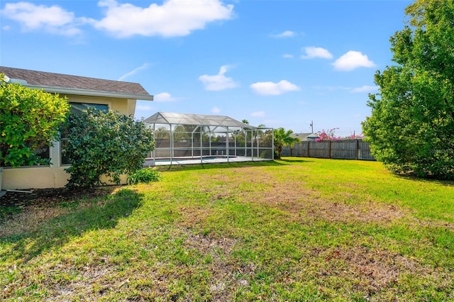 view of yard featuring a lanai and a fenced in pool