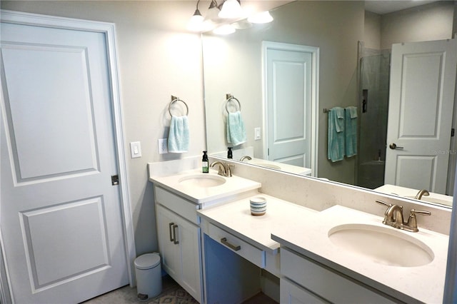 bathroom featuring a shower with door and vanity