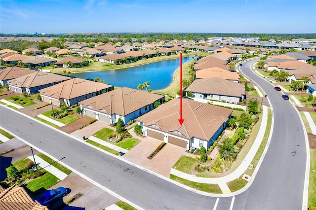 birds eye view of property featuring a water view and a residential view