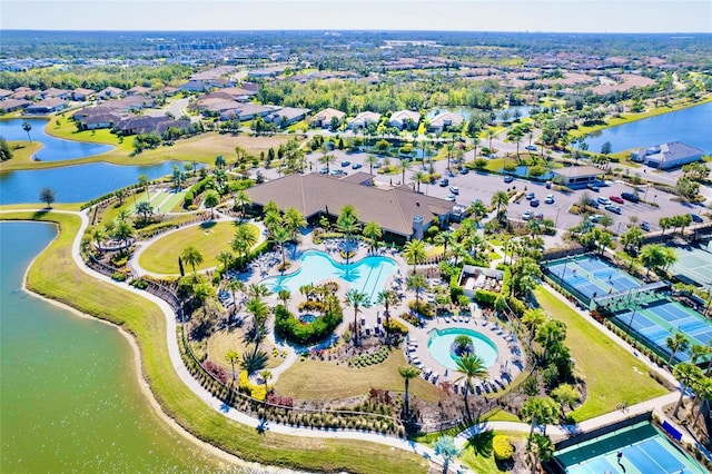 drone / aerial view with a water view and a residential view