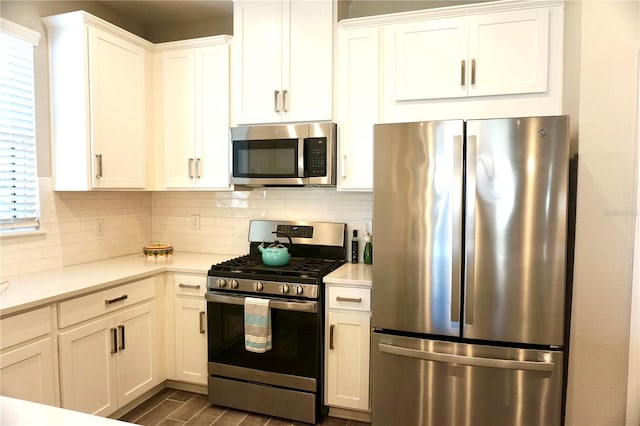 5426 Rushmere Ct, Palmetto, FL 34221 - kitchen with stainless steel appliances, light countertops, decorative backsplash, and white cabinetry