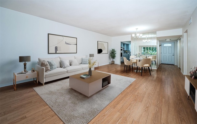 living room featuring a notable chandelier and hardwood / wood-style flooring