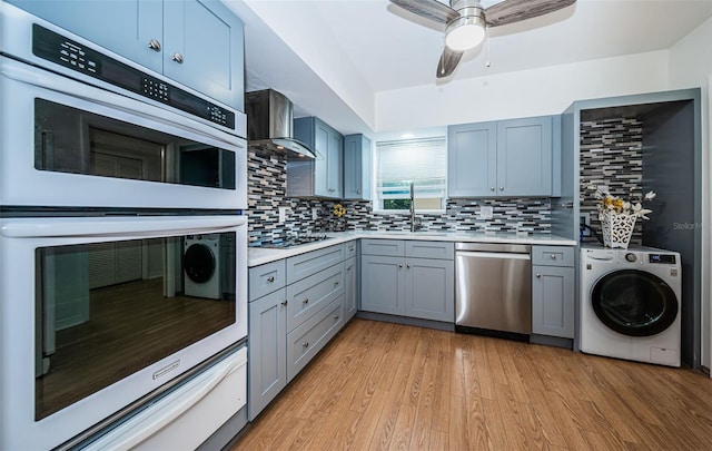 2258 World Parkway Blvd W Unit 8, Clearwater, FL 33763 - kitchen featuring dishwasher, washer / clothes dryer, double oven, wall chimney range hood, and light countertops