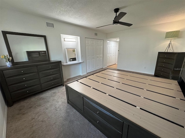2258 World Parkway Blvd W Unit 8, Clearwater, FL 33763 - unfurnished bedroom with a textured ceiling, carpet flooring, baseboards, and ceiling fan