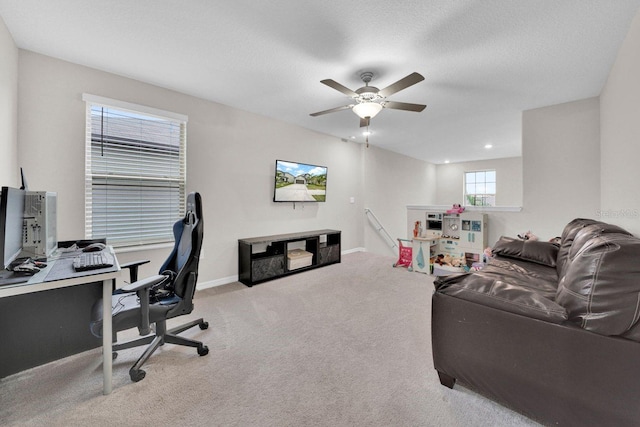 carpeted office space with ceiling fan and a textured ceiling