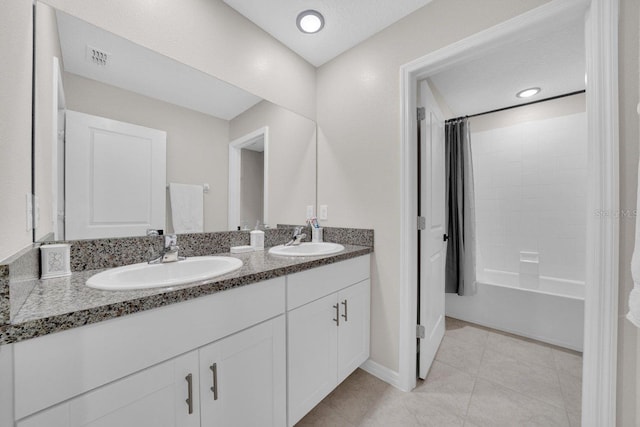 bathroom featuring vanity and shower / tub combo with curtain