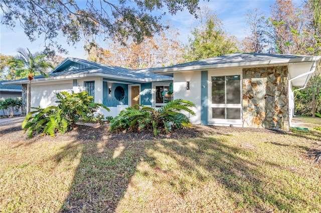 single story home with a front lawn and a garage