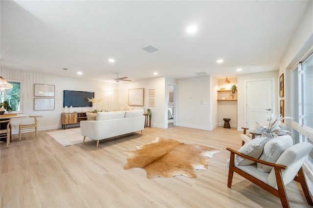 living room featuring ceiling fan and light wood-type flooring