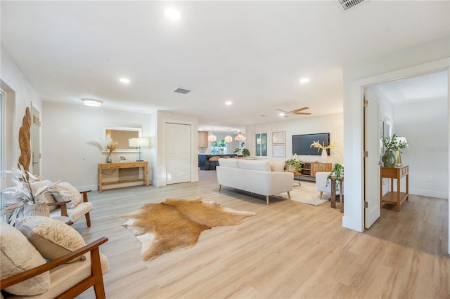 living room featuring light wood-type flooring and ceiling fan