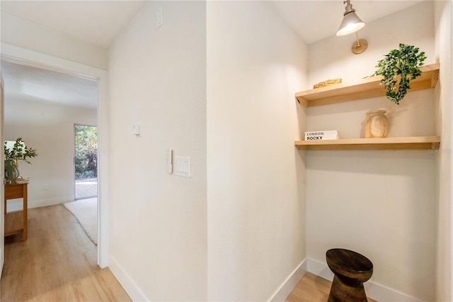 hallway with light hardwood / wood-style floors