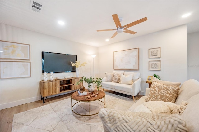 living room featuring ceiling fan and light wood-type flooring