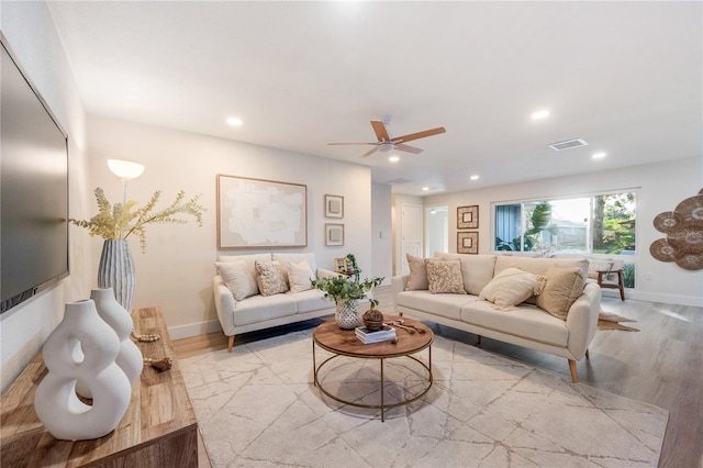 living room featuring ceiling fan and light hardwood / wood-style flooring