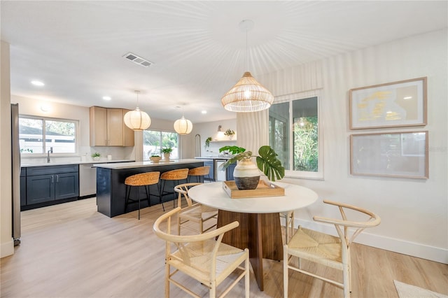 dining area featuring light hardwood / wood-style floors and sink