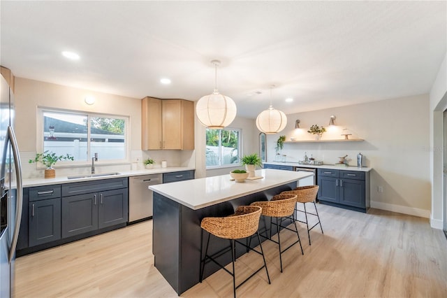 kitchen featuring stainless steel appliances, decorative backsplash, decorative light fixtures, a kitchen breakfast bar, and a center island