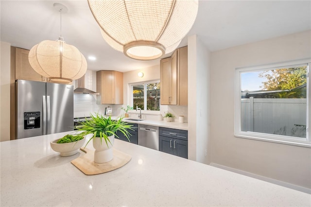 kitchen featuring stainless steel appliances, tasteful backsplash, light brown cabinets, hanging light fixtures, and sink