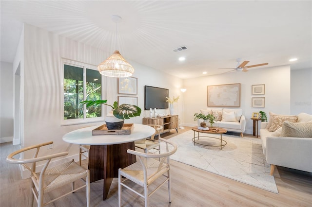 dining space featuring ceiling fan and light hardwood / wood-style flooring