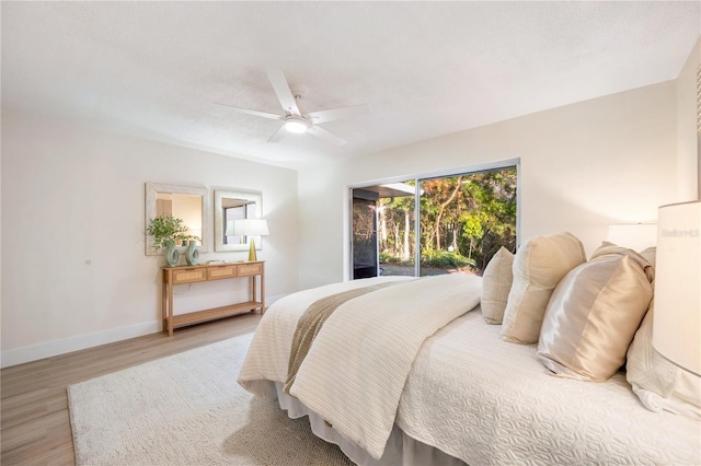 bedroom featuring a textured ceiling, ceiling fan, hardwood / wood-style flooring, and access to outside