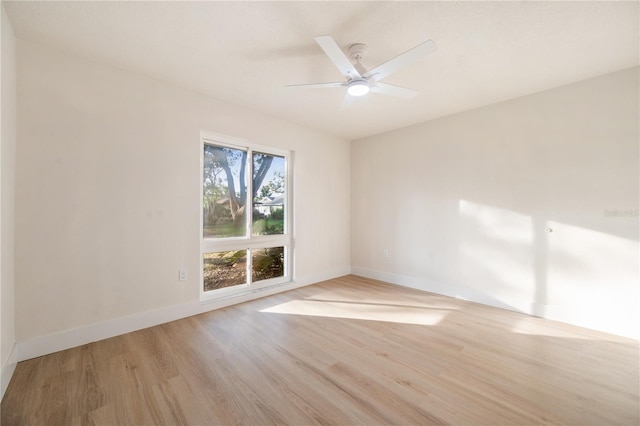 empty room with ceiling fan and light hardwood / wood-style floors