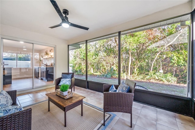 sunroom / solarium featuring ceiling fan