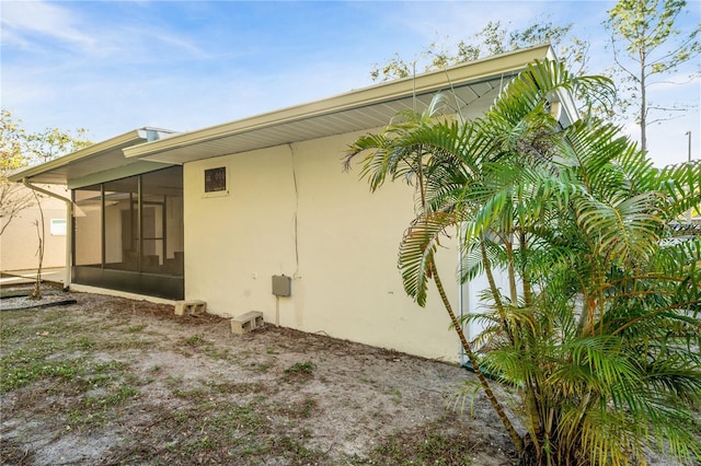 view of side of property with a sunroom