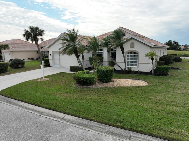 single story home featuring a garage and a front lawn