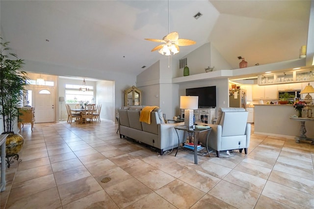 living room with ceiling fan, light tile patterned floors, and high vaulted ceiling