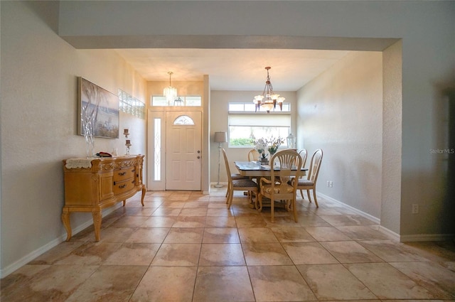 tiled dining area featuring an inviting chandelier