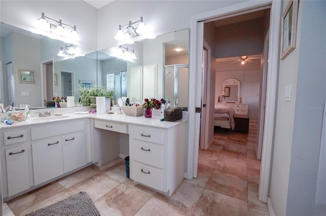 bathroom featuring ceiling fan, vanity, and a shower with shower door