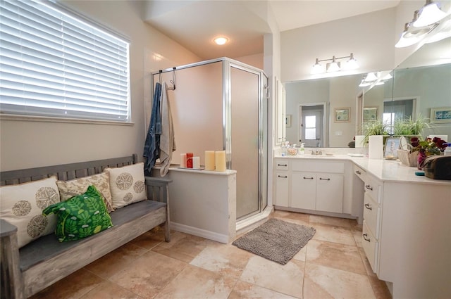 bathroom with vanity, plenty of natural light, and a shower with door