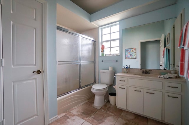 full bathroom featuring toilet, vanity, tile patterned floors, and enclosed tub / shower combo