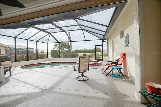 view of swimming pool with glass enclosure, a patio area, and an in ground hot tub