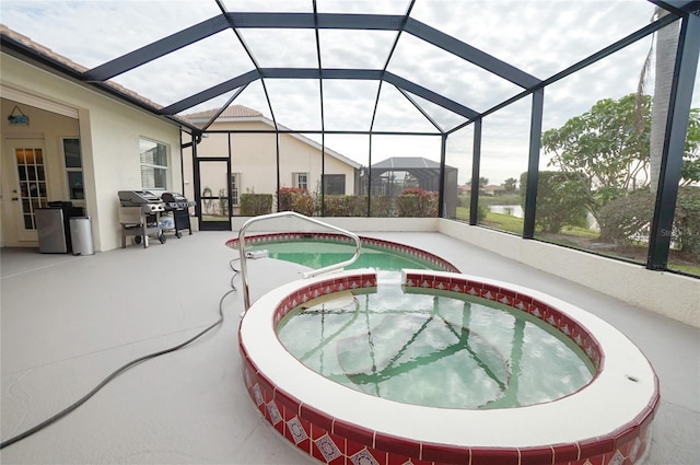 view of pool with glass enclosure, area for grilling, an in ground hot tub, and a patio