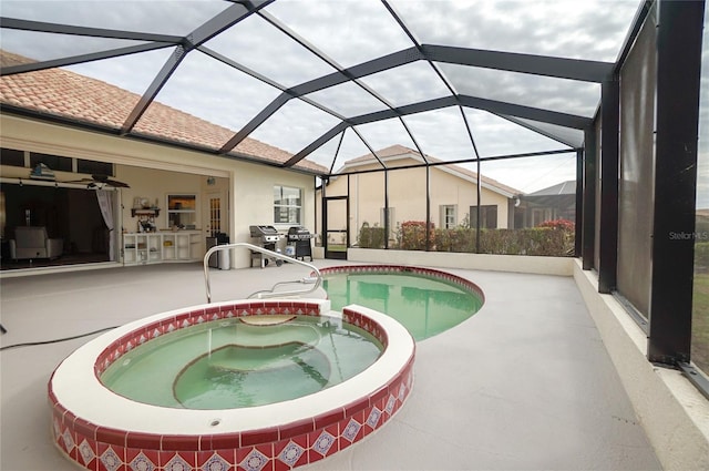 view of swimming pool featuring a patio area, a lanai, and an in ground hot tub