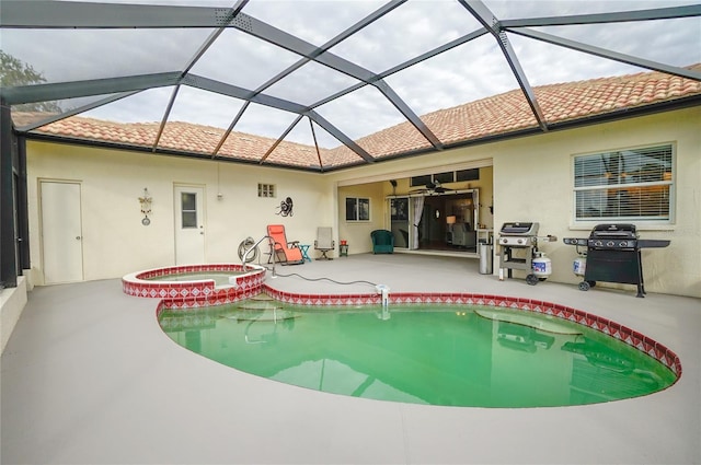 view of pool with glass enclosure, a patio area, an in ground hot tub, a grill, and ceiling fan