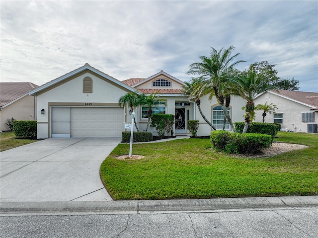 view of front of home featuring a front lawn and a garage