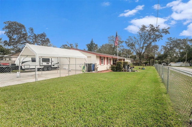 view of front of home with a carport and a front lawn