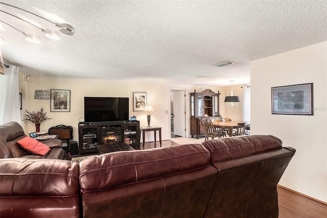 living room featuring hardwood / wood-style floors and a textured ceiling